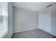 The bedroom features a large window with blinds, modern gray carpet, and a closet at 17032 Yellow Pine St, Wimauma, FL 33598