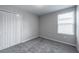 Bedroom featuring carpeted floors, closet and window bringing in natural light at 17032 Yellow Pine St, Wimauma, FL 33598