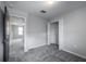 This bedroom features neutral walls, plush carpet, and an open closet for ample storage at 17032 Yellow Pine St, Wimauma, FL 33598