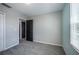 The bedroom offers gray carpet and walls plus natural light from the large window at 17032 Yellow Pine St, Wimauma, FL 33598
