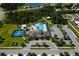 The community pool is surrounded by lush greenery, tennis courts, playground, and ample parking at 17032 Yellow Pine St, Wimauma, FL 33598