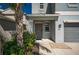 Welcoming front entrance with gray front door, adjacent window, stone landscaping and manicured shrubbery at 17032 Yellow Pine St, Wimauma, FL 33598