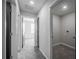 The hallway features modern gray walls, plush carpet, and access to several rooms at 17032 Yellow Pine St, Wimauma, FL 33598