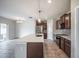 Kitchen island with stainless steel appliances, custom backsplash, granite countertops and pendant lighting at 17032 Yellow Pine St, Wimauma, FL 33598