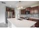 Kitchen island with stainless steel appliances, custom backsplash, granite countertops and pendant lighting at 17032 Yellow Pine St, Wimauma, FL 33598