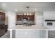 Kitchen island with stainless steel appliances, custom backsplash, and pendant lighting at 17032 Yellow Pine St, Wimauma, FL 33598