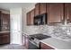 Modern kitchen featuring custom backsplash, stainless steel appliances and light countertops at 17032 Yellow Pine St, Wimauma, FL 33598