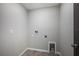 The functional laundry room has tile floors and the necessary hookups for your appliances at 17032 Yellow Pine St, Wimauma, FL 33598