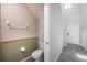 Neat powder room featuring a toilet and neutral color scheme, conveniently located near the foyer at 17032 Yellow Pine St, Wimauma, FL 33598