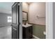Stylish powder room featuring a modern vanity, framed mirror, and neutral color scheme, conveniently located near the bedroom at 17032 Yellow Pine St, Wimauma, FL 33598