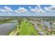 Expansive aerial view of a golf course community with ponds, lush greenery, and well-maintained homes at 1915 Pebble Beach Ct, Venice, FL 34293