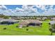 Aerial view of a residential property with a well-maintained lawn and landscaped yard at 1915 Pebble Beach Ct, Venice, FL 34293