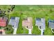 Aerial view of a home with a brown roof, a lush green lawn, and a screened-in lanai at 1915 Pebble Beach Ct, Venice, FL 34293