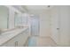 Bathroom featuring double sinks with marble countertops, and a glass shower at 1915 Pebble Beach Ct, Venice, FL 34293