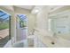 Bright bathroom with views of pool and lanai at 1915 Pebble Beach Ct, Venice, FL 34293