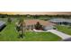 Charming home with lush landscaping and a well-manicured lawn at 1915 Pebble Beach Ct, Venice, FL 34293