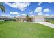 Charming single-story home featuring a well-manicured front lawn and inviting curb appeal at 1915 Pebble Beach Ct, Venice, FL 34293