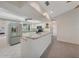 Open kitchen featuring stainless steel appliances, granite counters and a convenient breakfast bar at 1915 Pebble Beach Ct, Venice, FL 34293