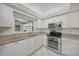 Bright kitchen featuring stainless steel appliances, granite counters, and a double oven at 1915 Pebble Beach Ct, Venice, FL 34293