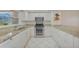 Kitchen features stainless appliances, granite countertops, and white cabinets at 1915 Pebble Beach Ct, Venice, FL 34293