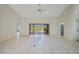 Spacious open room leading to outdoor pool and patio area at 1915 Pebble Beach Ct, Venice, FL 34293