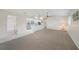 Bright living space with carpet, a dining area, and a view of the kitchen at 1915 Pebble Beach Ct, Venice, FL 34293