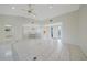Bright, open living room with tile floors and easy access to dining and other living areas at 1915 Pebble Beach Ct, Venice, FL 34293