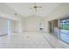 Spacious living room featuring vaulted ceilings, tile floors, and a view into the main bedroom at 1915 Pebble Beach Ct, Venice, FL 34293