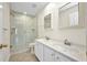 Bright bathroom featuring a double vanity, glass shower, and tile flooring at 200 Valdiva St, Punta Gorda, FL 33983