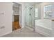 Bathroom featuring a glass shower, bathtub, and access to a walk-in closet at 200 Valdiva St, Punta Gorda, FL 33983