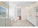 Spacious bathroom with double vanity, glass shower, and a doorway to a bedroom at 200 Valdiva St, Punta Gorda, FL 33983