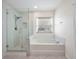 Bright bathroom with glass shower, bathtub, and ample natural light at 200 Valdiva St, Punta Gorda, FL 33983
