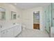 Bright bathroom featuring a double vanity, glass shower, and tile flooring at 200 Valdiva St, Punta Gorda, FL 33983