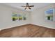 Bedroom features wood floors, a ceiling fan, and a bright window at 200 Valdiva St, Punta Gorda, FL 33983