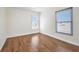 Bright bedroom featuring hardwood floors and natural light from two windows at 200 Valdiva St, Punta Gorda, FL 33983
