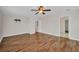 Large bedroom with wood floors, ceiling fan, and access to other rooms at 200 Valdiva St, Punta Gorda, FL 33983