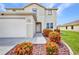 Beautiful two-story home featuring a white exterior, a garage, and manicured landscaping at 200 Valdiva St, Punta Gorda, FL 33983