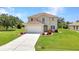 Charming two-story home features a well-manicured lawn and attached two-car garage at 200 Valdiva St, Punta Gorda, FL 33983
