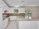 Modern kitchen featuring white cabinets, granite countertops, and stainless steel appliances at 200 Valdiva St, Punta Gorda, FL 33983