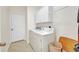 Laundry room featuring washer, dryer, cabinets, and tile flooring at 200 Valdiva St, Punta Gorda, FL 33983