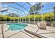 Relax in this refreshing in-ground pool in a screened enclosure with a comfortable place to sit at 200 Valdiva St, Punta Gorda, FL 33983