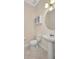 Cozy half-bath features a pedestal sink, toilet, and mirrored cabinet, perfect for guests at 200 Valdiva St, Punta Gorda, FL 33983