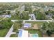 Drone shot showcases home's position among lush trees, neighborhood streets, and serene environment at 20409 Emerald Ave, Port Charlotte, FL 33952