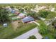Aerial perspective highlighting the property's lush green landscape and surrounding neighborhood with mature trees at 20409 Emerald Ave, Port Charlotte, FL 33952