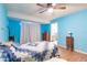 Cozy bedroom with ceiling fan, wood floors, and ample natural light at 20409 Emerald Ave, Port Charlotte, FL 33952
