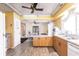 Bright kitchen with wood floors, wood cabinets, and stainless steel sink beneath a large window at 20409 Emerald Ave, Port Charlotte, FL 33952