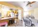 Open kitchen and dining area featuring wood floors, ceiling fans and ample natural light at 20409 Emerald Ave, Port Charlotte, FL 33952