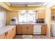 Kitchen featuring wood floors, wood cabinets, stainless steel sink, and modern appliances at 20409 Emerald Ave, Port Charlotte, FL 33952