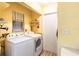 Laundry room featuring washer and dryer with a bright yellow color at 20409 Emerald Ave, Port Charlotte, FL 33952