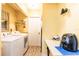 Laundry room featuring washer and dryer with a bright yellow color at 20409 Emerald Ave, Port Charlotte, FL 33952